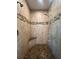 Walk-in shower with decorative tile accents, a glass door, and a built-in corner seat at 460 137Th Avenue Cir, Madeira Beach, FL 33708