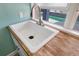 Close-up on a pristine utility sink with a modern faucet and a pool view from the window at 460 137Th Avenue Cir, Madeira Beach, FL 33708
