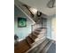 Stairway with wood and iron railing and decorative wood-look accent wall at 460 137Th Avenue Cir, Madeira Beach, FL 33708