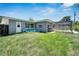 Private backyard featuring a screened pool area, open green space, and patio with lawn furniture for relaxation at 4753 48Th N Ave, St Petersburg, FL 33714