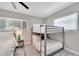 Cozy bedroom featuring a bunk bed, twin bed, and side table with a lamp at 4753 48Th N Ave, St Petersburg, FL 33714