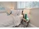 Bedroom with white linens, a side table, and a lamp by the window at 4753 48Th N Ave, St Petersburg, FL 33714
