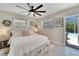 This bright bedroom has an overhead fan and an adjacent pool view at 4753 48Th N Ave, St Petersburg, FL 33714