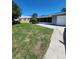 A lovely view of the front yard showing the house, lawn, and driveway at 4753 48Th N Ave, St Petersburg, FL 33714