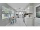 Bright, white kitchen features stainless steel appliances, eat-in area and stylish countertops at 4753 48Th N Ave, St Petersburg, FL 33714