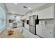 Bright, white kitchen with stainless steel appliances, stylish countertops, and modern design at 4753 48Th N Ave, St Petersburg, FL 33714