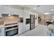 Modern kitchen featuring white cabinets and stainless steel appliances, ample storage space, and white tile at 4753 48Th N Ave, St Petersburg, FL 33714