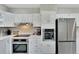 Modern kitchen features stainless appliances, white cabinets and countertops, plus recessed lighting at 4753 48Th N Ave, St Petersburg, FL 33714
