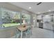 Modern kitchen with white cabinets, stainless appliances, large windows, and bright light at 4753 48Th N Ave, St Petersburg, FL 33714