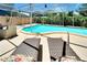 Relaxing pool area with lounge chairs, covered patio, and well-maintained landscaping at 4753 48Th N Ave, St Petersburg, FL 33714