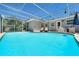 Spacious screened-in pool area with ample seating, perfect for entertaining and relaxation at 4753 48Th N Ave, St Petersburg, FL 33714