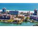 Waterfront condo complex boasts beautiful beach access with a nearby harbor and city buildings in the background at 5353 Gulf Blvd # B103, St Pete Beach, FL 33706