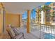 Enjoy the waterfront views from this balcony with tiled floor and chairs overlooking lush landscaping at 5353 Gulf Blvd # B103, St Pete Beach, FL 33706