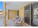 Private balcony with comfortable rocking chairs and peaceful views at 5353 Gulf Blvd # B103, St Pete Beach, FL 33706
