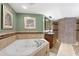Large soaking tub and mosaic tile shower featured in the bathroom at 5353 Gulf Blvd # B103, St Pete Beach, FL 33706
