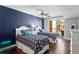 Bright bedroom featuring two twin beds, dark hardwood floors, and a sliding glass door to the balcony at 5353 Gulf Blvd # B103, St Pete Beach, FL 33706