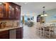 Open-concept living space flows from kitchen to dining room with beautiful waterfront views at 5353 Gulf Blvd # B103, St Pete Beach, FL 33706