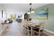 Cozy dining area adjacent to the living room featuring a coastal aesthetic and serene ambiance at 5353 Gulf Blvd # B103, St Pete Beach, FL 33706