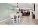 Bright dining area with views into the kitchen with a breakfast bar at 5353 Gulf Blvd # B103, St Pete Beach, FL 33706