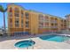 Stunning condo building featuring a pool, hot tub, and marina access at 5353 Gulf Blvd # B103, St Pete Beach, FL 33706