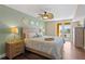 Bright main bedroom featuring balcony access, ceiling fan and an ensuite bathroom at 5353 Gulf Blvd # B103, St Pete Beach, FL 33706