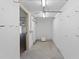 Clean storage room ready for your customization with bright lighting and an open door at 5353 Gulf Blvd # B103, St Pete Beach, FL 33706