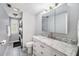 Updated bathroom with modern vanity, marble countertop, and neutral decor at 5910 River Rd, New Port Richey, FL 34652