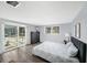 Bright bedroom with sliding door access to the pool area and a view to the backyard at 5910 River Rd, New Port Richey, FL 34652