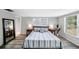 Comfortable bedroom with a queen sized bed, natural light, and stylish decor at 5910 River Rd, New Port Richey, FL 34652