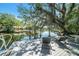 Dock with two chairs overlooking the canal, surrounded by trees with hanging moss at 5910 River Rd, New Port Richey, FL 34652