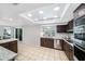 Bright kitchen features lots of cabinets, modern appliances, and a view to the backyard at 5910 River Rd, New Port Richey, FL 34652