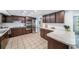 Spacious kitchen featuring wood cabinets, tile backsplash, and stainless steel appliances at 5910 River Rd, New Port Richey, FL 34652