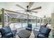 Relaxing lanai features comfortable seating, ceiling fans and a view of the inviting pool and lush backyard at 5910 River Rd, New Port Richey, FL 34652