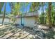 Backyard outbuilding with a cement foundation and siding, surrounded by mature trees at 5910 River Rd, New Port Richey, FL 34652