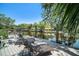 Inviting waterfront dock features two lounge chairs with stunning views of the waterway and surrounding natural landscape at 5910 River Rd, New Port Richey, FL 34652