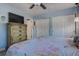 Light and airy bedroom with a ceiling fan, large closet, and dresser with a flatscreen TV above it at 5931 33 N Ave, St Petersburg, FL 33710