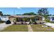 Inviting home with mature landscaping, green lawn, and charming curb appeal at 5931 33 N Ave, St Petersburg, FL 33710