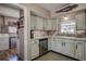 Cozy kitchen features neutral cabinets, stone tile backsplash and stainless dishwasher at 5931 33 N Ave, St Petersburg, FL 33710