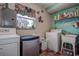 Functional laundry room includes washer, dryer, utility sink, and ample storage space at 5931 33 N Ave, St Petersburg, FL 33710