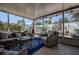 Relaxing sunroom with cozy furniture and views of the landscaped backyard at 5931 33 N Ave, St Petersburg, FL 33710