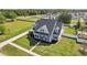 Aerial view of the home showcasing its mature landscaping, white picket fence, and inviting front porch at 6518 Paw Pl, Land O Lakes, FL 34639