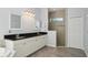 Bathroom boasts dual sinks, tile floors, a glass shower, and a large closet at 6518 Paw Pl, Land O Lakes, FL 34639