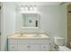Bright bathroom with double sink vanity, white cabinets, and neutral walls at 6518 Paw Pl, Land O Lakes, FL 34639