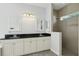 Bathroom boasts dual sinks, tile floors, a glass shower and lots of light at 6518 Paw Pl, Land O Lakes, FL 34639