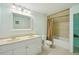 Bright bathroom with double sink vanity, white cabinets, and shower-tub combination at 6518 Paw Pl, Land O Lakes, FL 34639
