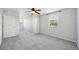 Bright bedroom features a ceiling fan, a window, neutral walls, and plush carpeting at 6518 Paw Pl, Land O Lakes, FL 34639