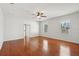 Spacious bedroom with hardwood floors, a ceiling fan, and lots of natural light at 6518 Paw Pl, Land O Lakes, FL 34639