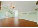 Large bonus room with vaulted ceilings, wood-look floors, and modern ceiling fan at 6518 Paw Pl, Land O Lakes, FL 34639