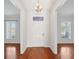 Bright foyer showcasing hardwood floors and a decorative transom window above the front door at 6518 Paw Pl, Land O Lakes, FL 34639