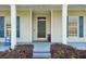 Inviting front door with decorative wreath and sidelights, framed by white columns at 6518 Paw Pl, Land O Lakes, FL 34639